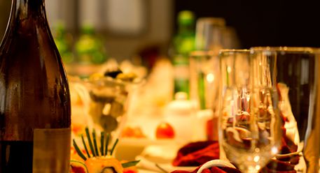 A table arranged for a meal with a bottle of champagne 