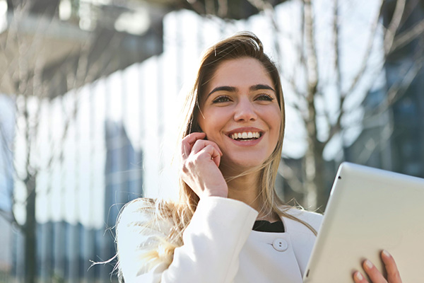 A person on a call holding a tablet 